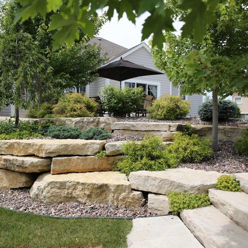 Rustic gold flamed steps with seamface and splitface outcropping