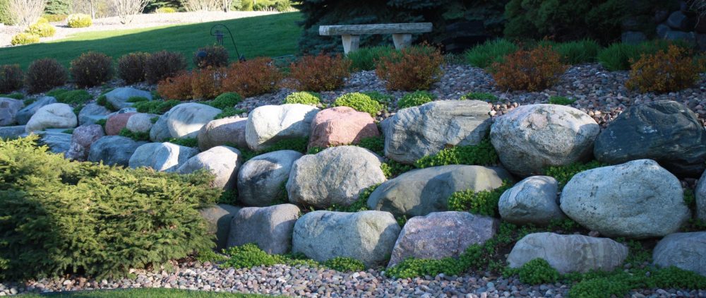 WI Granite Boulders Installed as a Retaining Wall